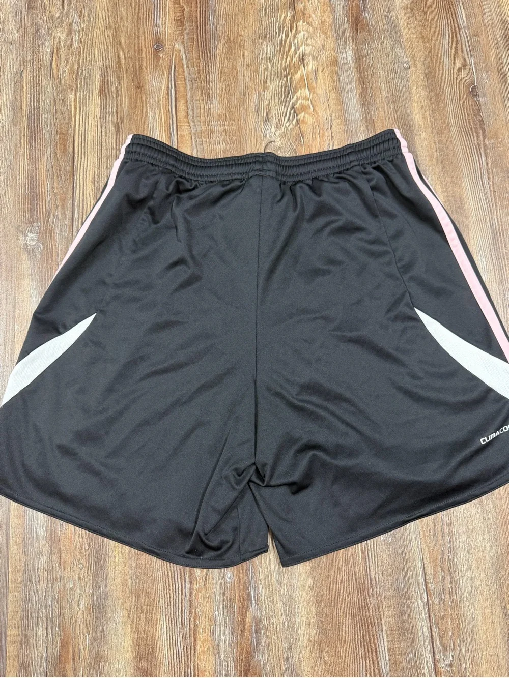 Adidas black shorts with baby pink and white stripes on sides, size S